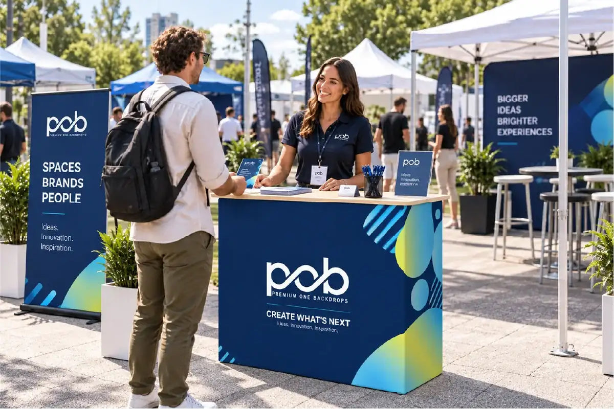 Custom branded fabric pop up counter used for visitor registration and promotions at an outdoor event