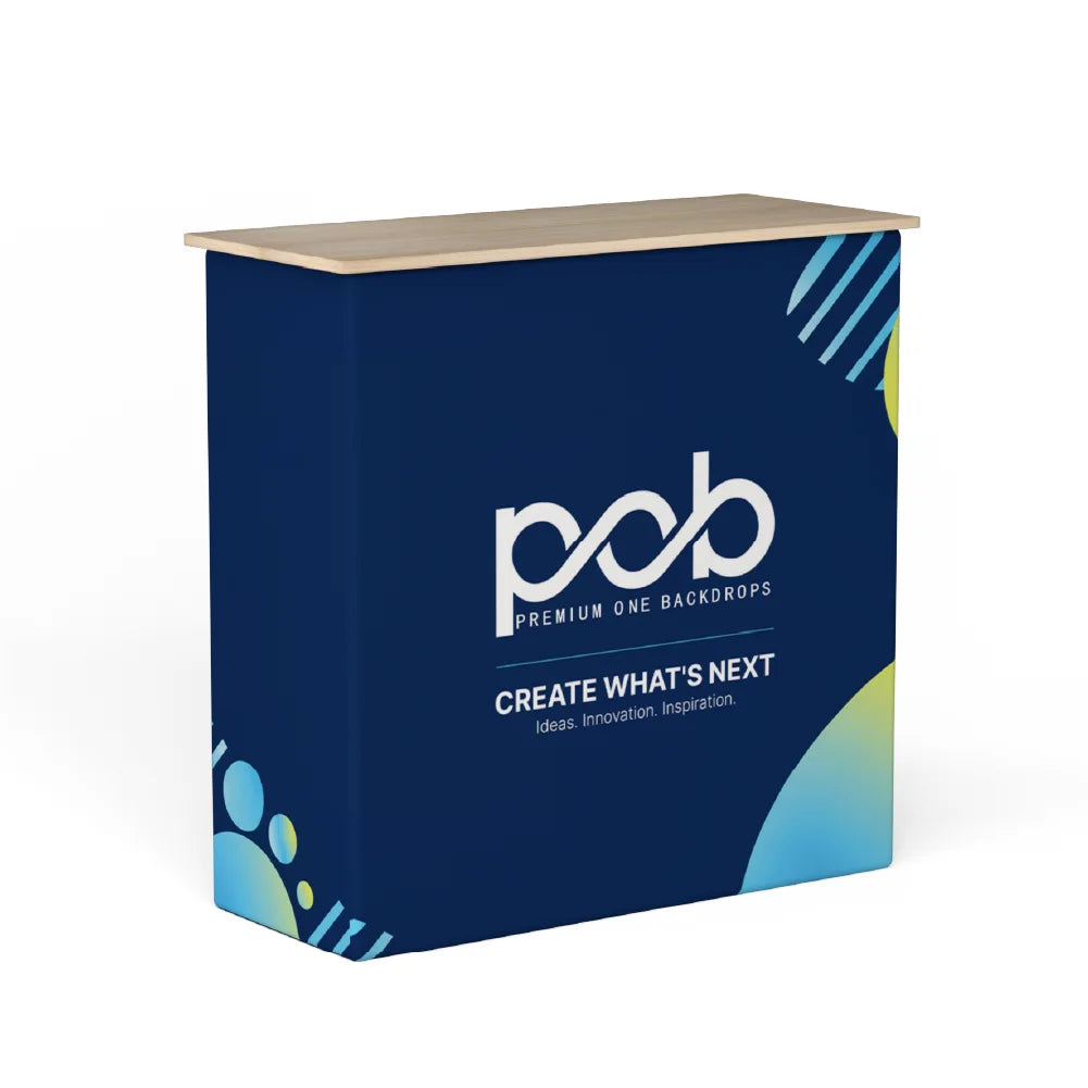 Custom printed fabric pop up counter display with navy blue graphics and a light wood tabletop