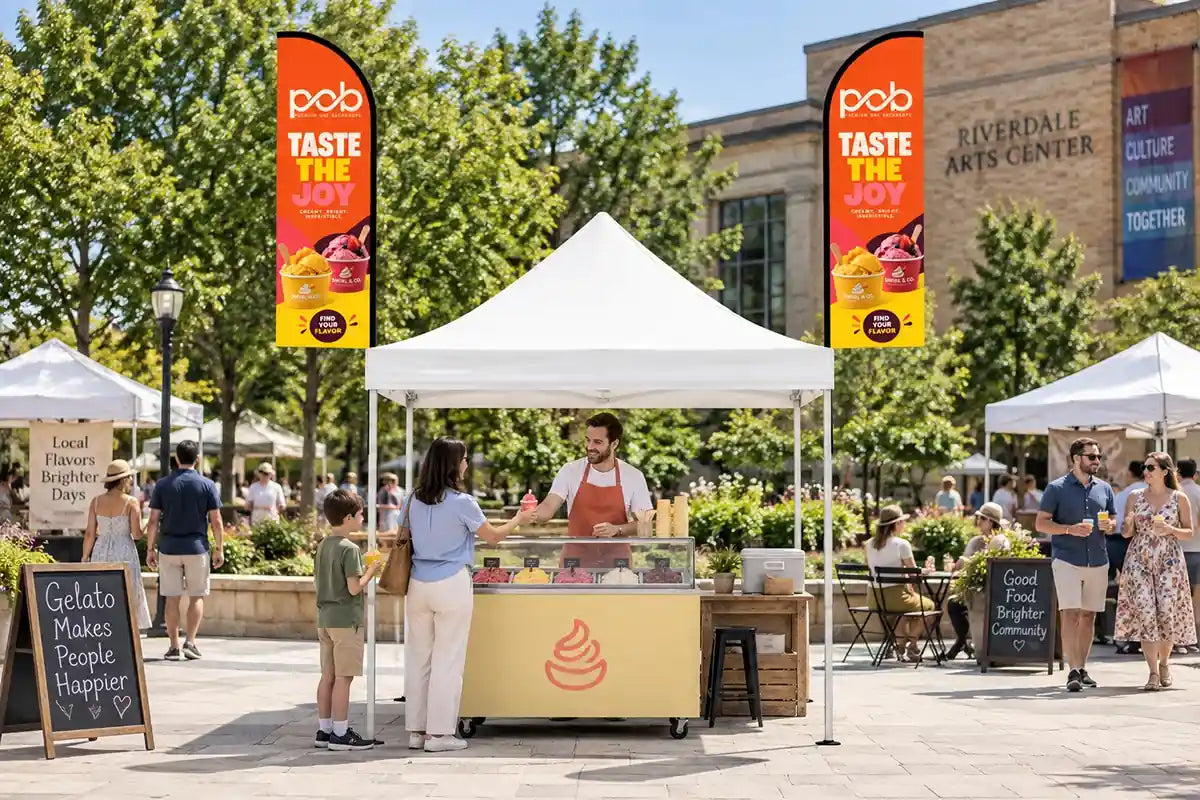 Custom feather flags attached to both sides of a canopy tent at an outdoor gelato stand