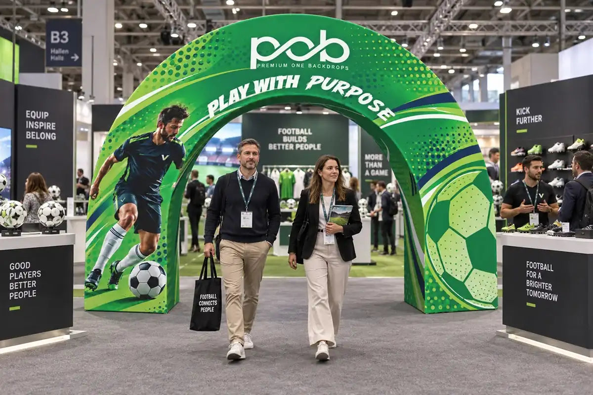 Green 3D archway display with soccer graphics welcoming visitors at a sports trade show