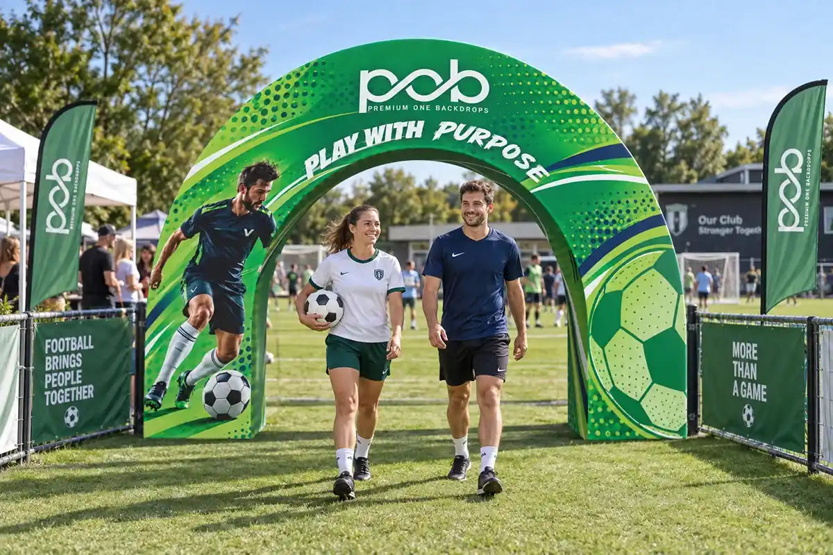 Green 3D archway display with soccer-themed printing at an outdoor football event entrance