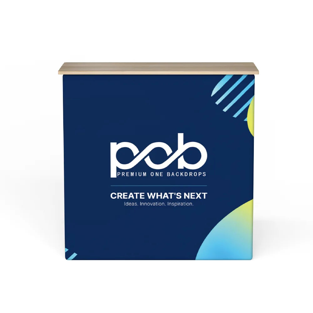 Front view of a fabric pop up counter display with navy blue printed graphics and a wood-look countertop