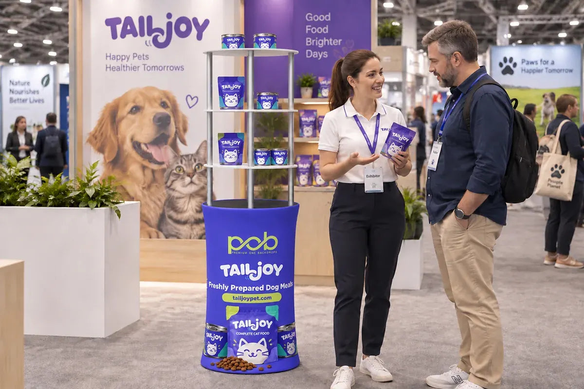 Oval display rack showcasing packaged pet food products at an indoor pet industry trade show