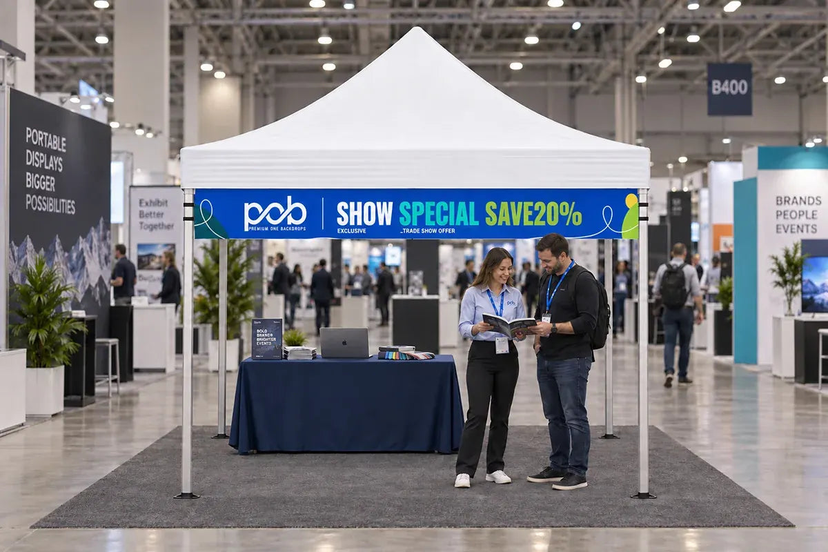 Custom printed canopy valance banner featuring a promotional message at a busy trade show booth